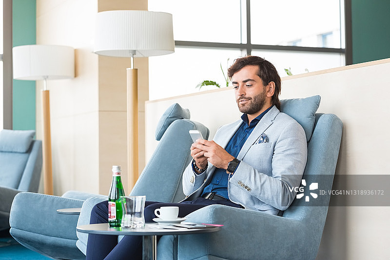 在机场使用智能手机的商人图片素材