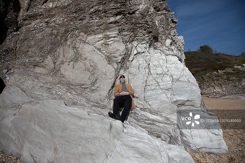 男子在德文郡海岸线上放松图片素材
