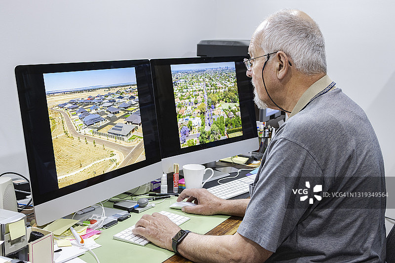 年长的男人在家用电脑处理照片图片素材