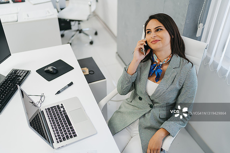 在办公室使用手机的年轻女商人图片素材