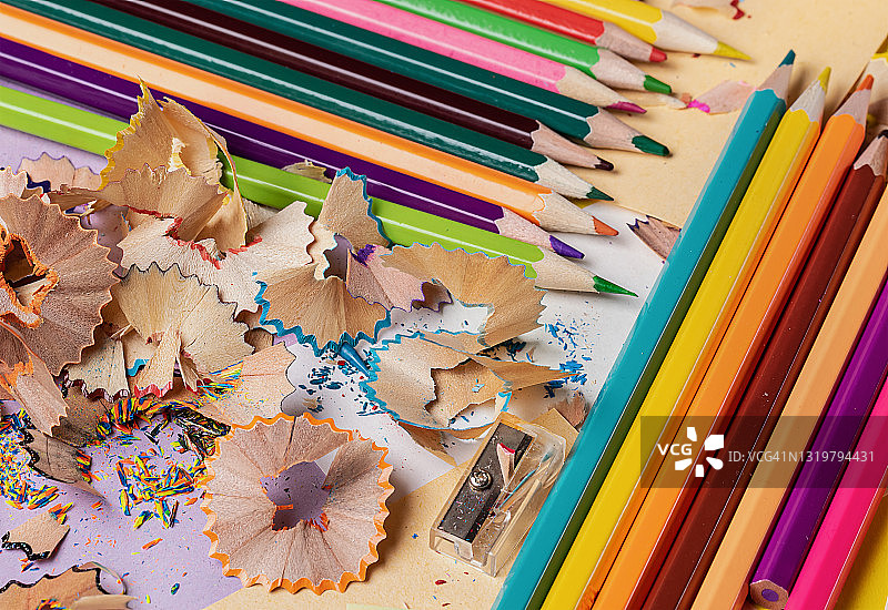 黄色背景上的彩色铅笔和卷笔刀图片素材