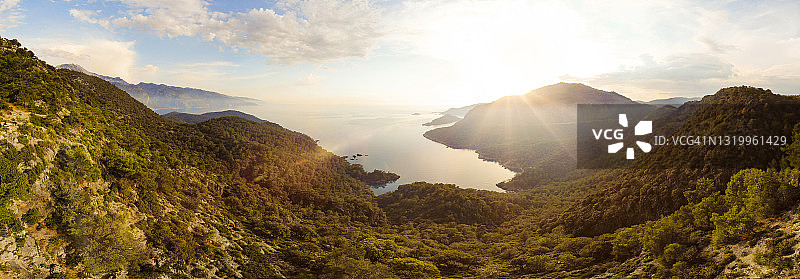 日出时分，俯瞰山谷通往偏远海岸线的全景航拍图片素材