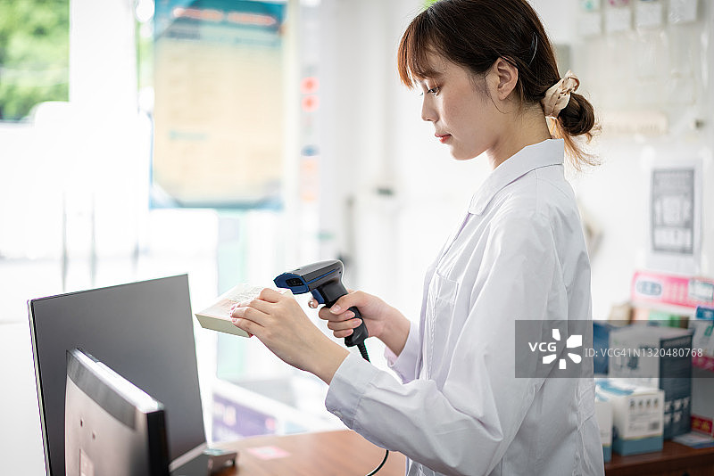 女药剂师扫描药品价格图片素材