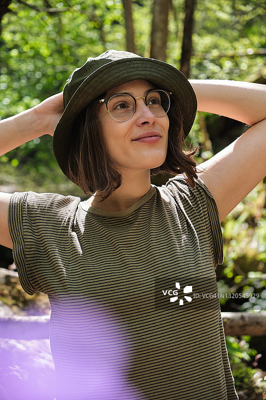 在树林里徒步旅行的年轻女子肖像图片素材