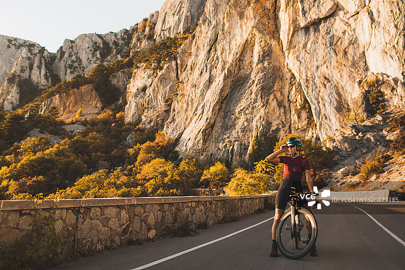 公路自行车上的自行车女运动员肖像图片素材