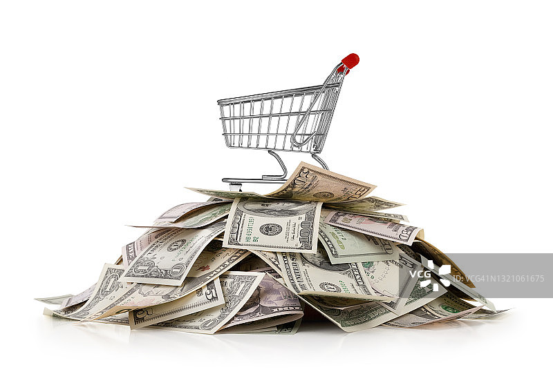 堆放在美元钞票顶部的购物车图片素材