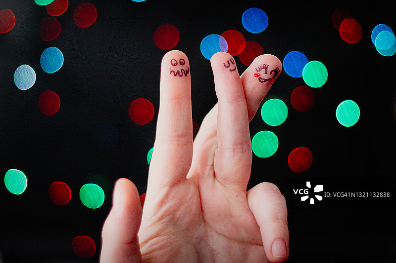 三根带有小脸的手指：代表一对恋人和一个嫉妒者，浅色背景图片素材