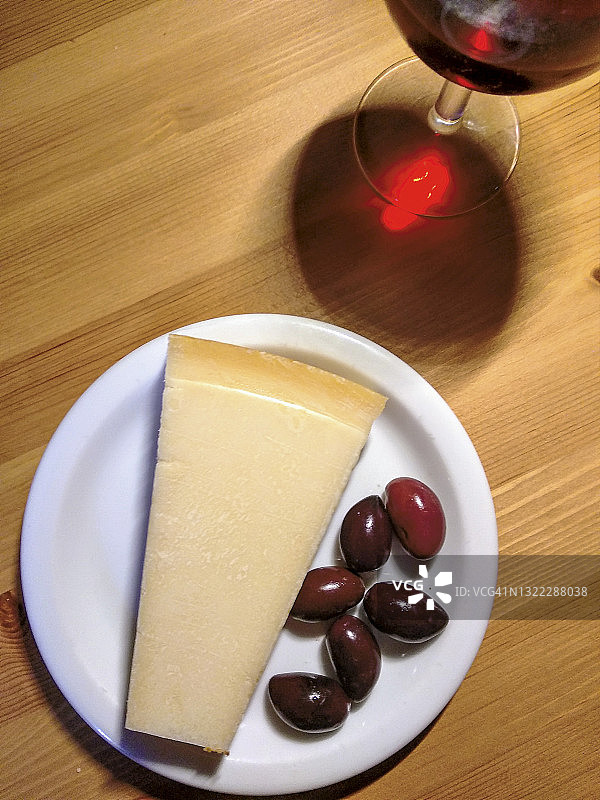 新鲜的帕达诺干酪、红酒和黑橄榄图片素材