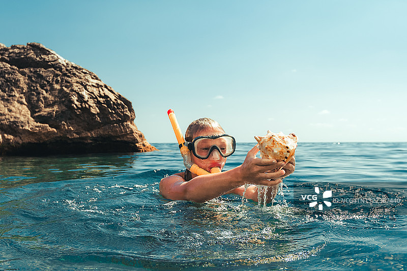 女孩从海底拿出贝壳图片素材