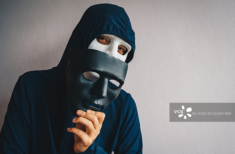 戴头罩和黑客面具的神秘男子肖像图片素材