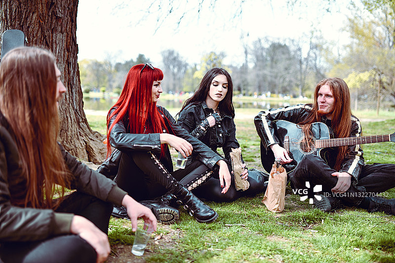 情侣在公园里弹吉他喝酒图片素材