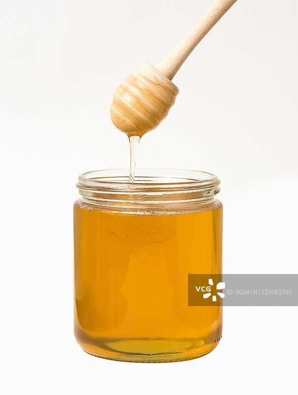 玻璃罐中未搅拌的菜籽蜜图片素材