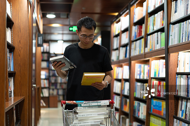 亚洲男图书管理员整理书籍图片素材