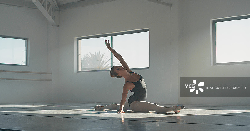 年轻女子在舞蹈工作室练习芭蕾舞全身照图片素材