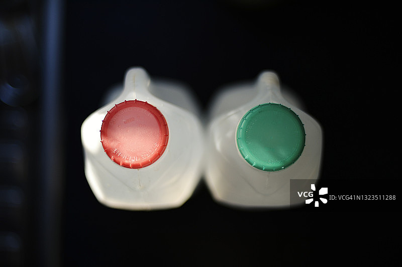 带有绿色和红色螺旋盖的塑料牛奶瓶图片素材