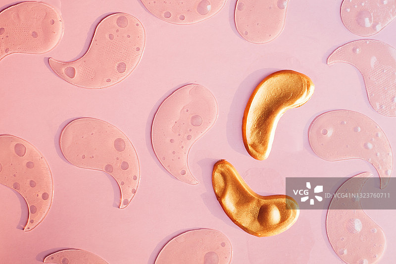 粉色背景上的眼罩图案，水凝胶美容眼贴，平铺俯视图片素材