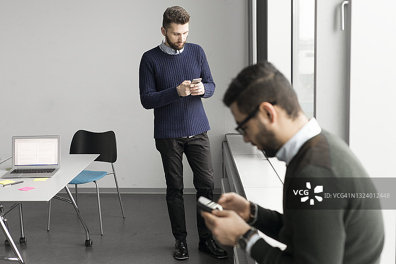 工作中查看手机的男人图片素材