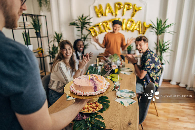 男人带蛋糕参加生日派对图片素材