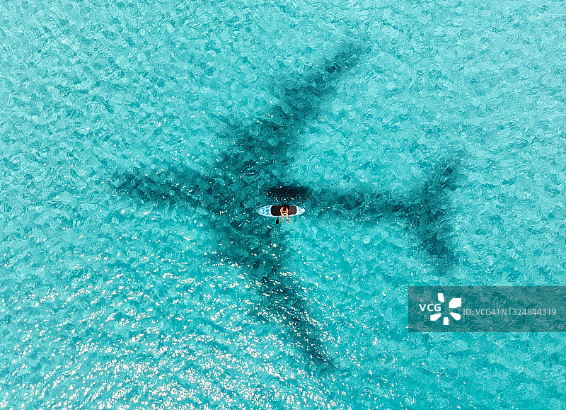 天堂般的海滩上桨板运动者航拍景色图片素材