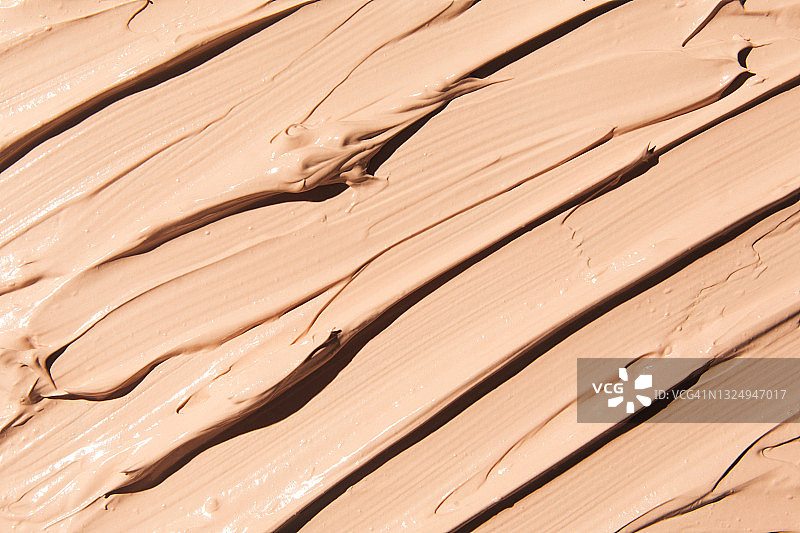 浅棕色或米色化妆品BB霜、CC霜粉底液背景图片素材