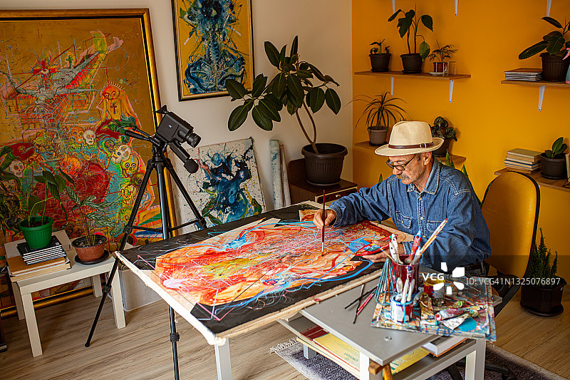 老年画家录制在线艺术课程，讲解绘画技巧图片素材