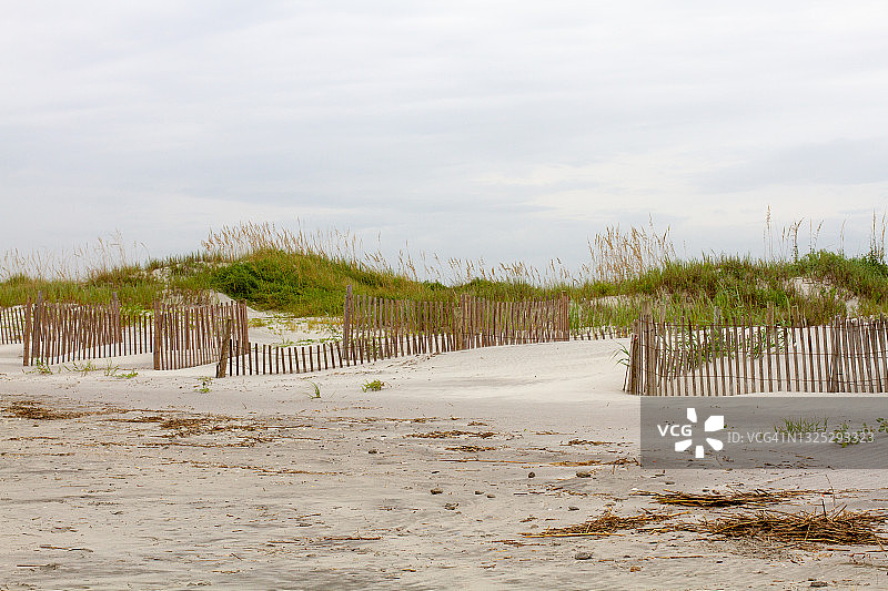 阴天海岸沙丘上的沙栅栏图片素材