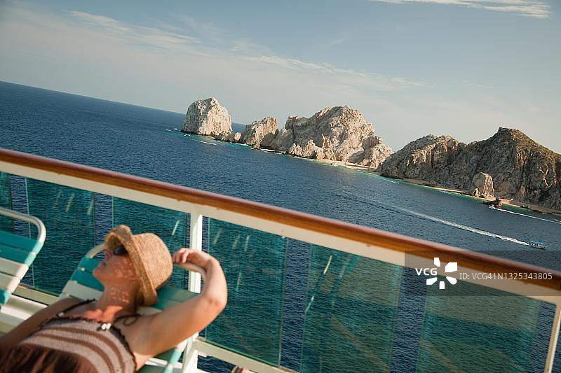 美丽的女人在墨西哥卡波圣卢卡斯游轮甲板上放松图片素材
