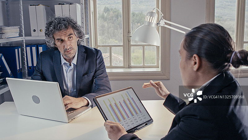 商务人士在办公室合作项目，集思广益。在无纸化办公空间工作，实现可持续发展目标。图片素材