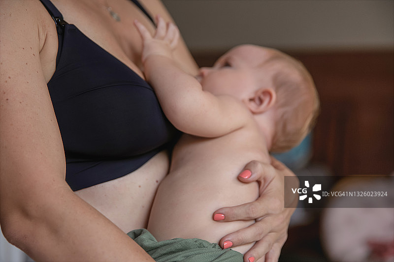 白人母亲抱着男婴并进行母乳喂养图片素材