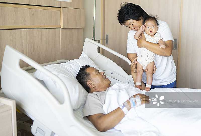 亚洲家庭祖母拥抱孙女，鼓励祖父早日康复的家庭生活场景图片素材