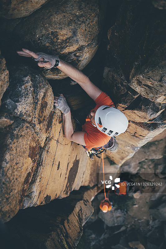 一名男性攀岩者在不列颠哥伦比亚省弗农附近的高处裂缝中放置手的俯视图图片素材
