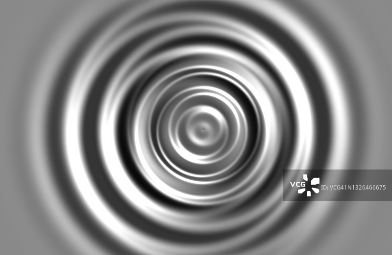 银色液体滴落形成的同心圆图片素材