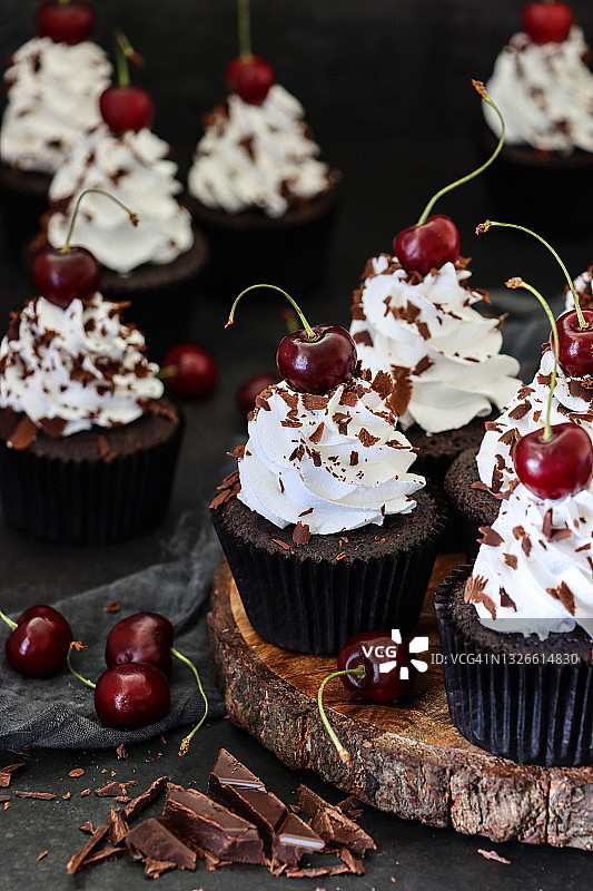 黑森林蛋糕纸杯蛋糕，奶油和黑樱桃装饰图片素材