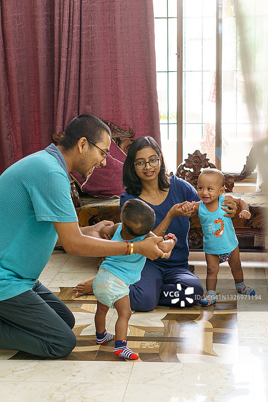 印度父母和他们的年轻双胞胎儿子玩耍图片素材
