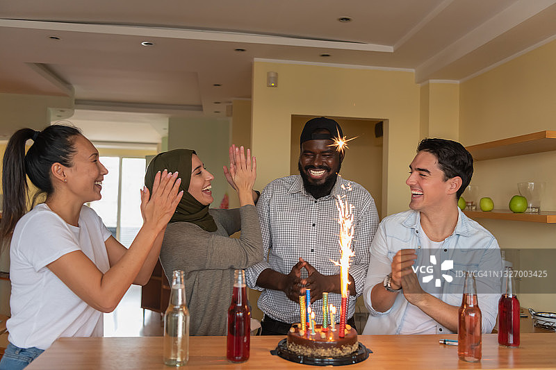 一群好友为年轻的非裔美国朋友庆祝生日照片图片素材