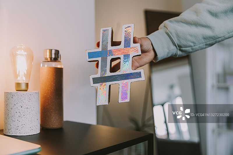 在家拿着全息标签符号的女人图片素材