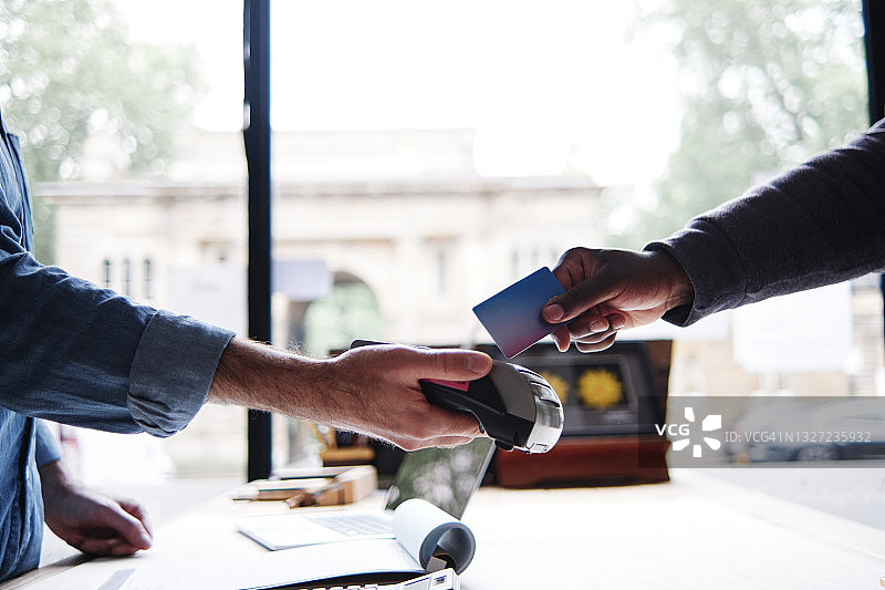 男人在工坊使用信用卡付款图片素材