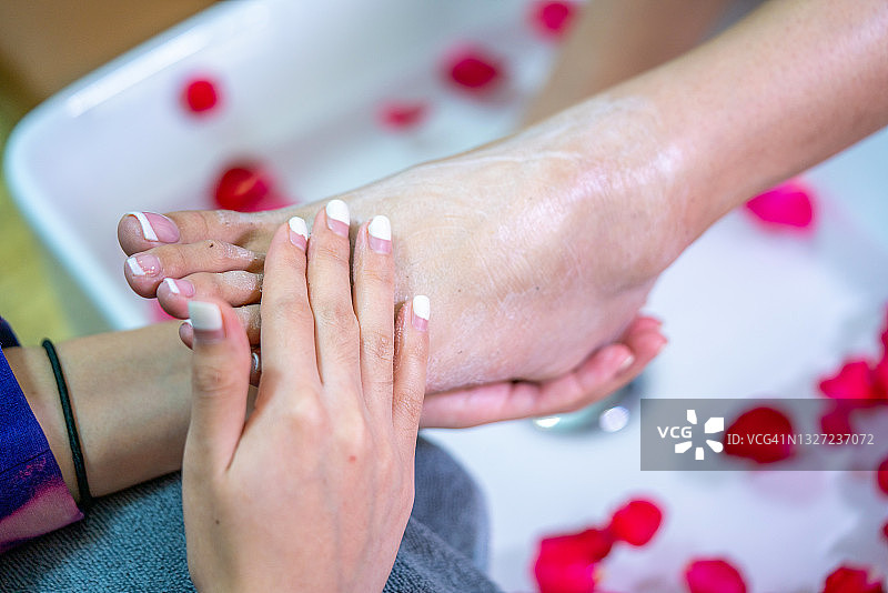 女人在水疗中心享受足部按摩（足部特写）图片素材