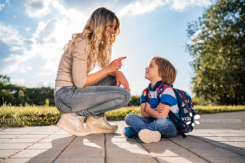 不开心的男孩和他的妈妈在公园里图片素材