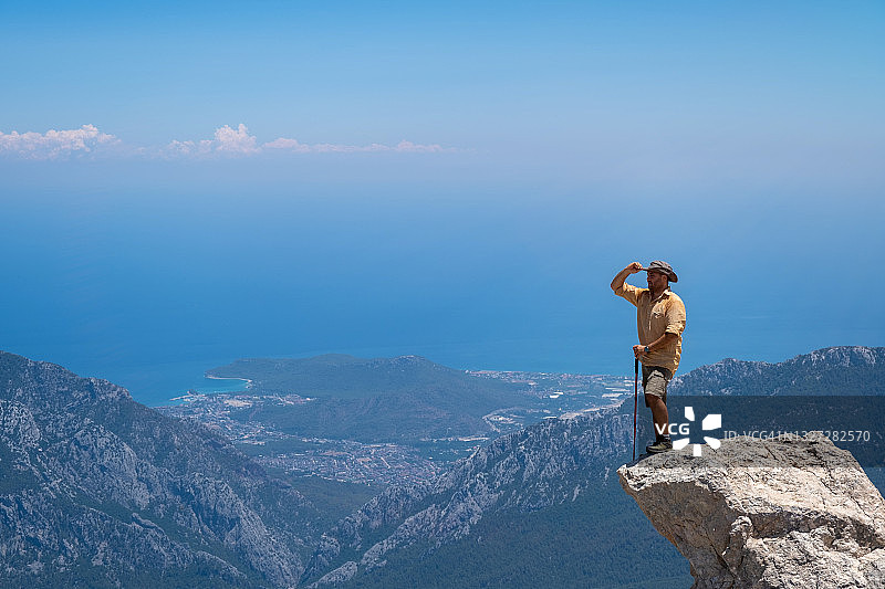 男模特在高海拔岩石上眺望地中海山脉图片素材