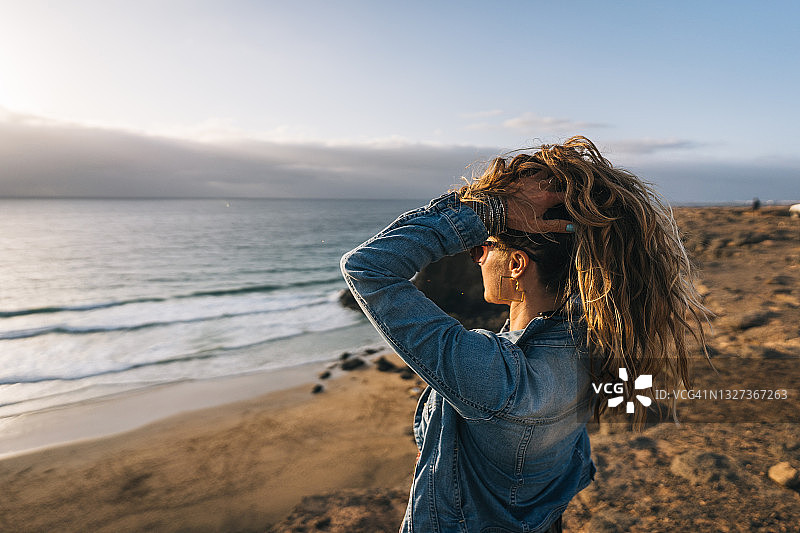 在海边观景点放下头发的年轻女人图片素材