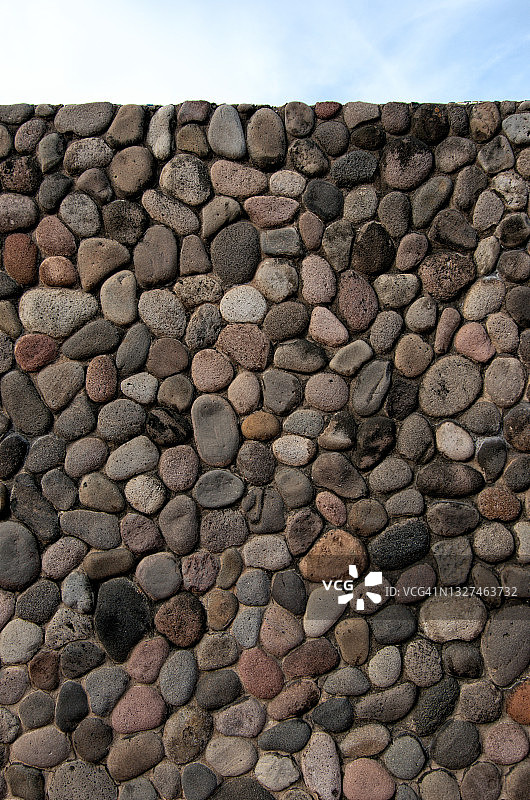 圆形卵石和混凝土墙之上的天空图片素材