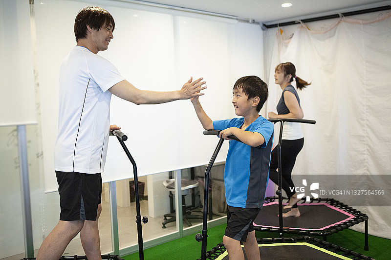 在健身房蹦床上进行家庭训练图片素材