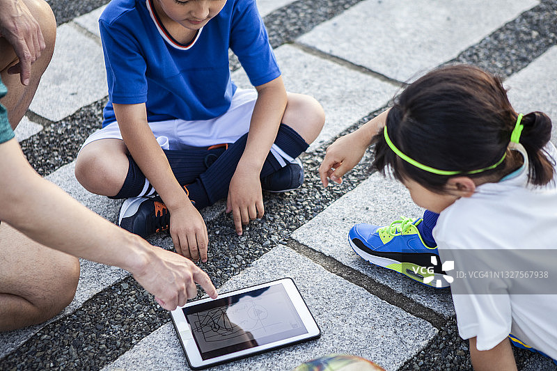 儿童足球运动员使用平板电脑进行战术会议图片素材