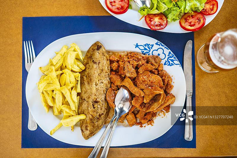 葡萄牙阿连特茹传统美食：酱汁牛舌配沙拉、米饭和炸薯条图片素材