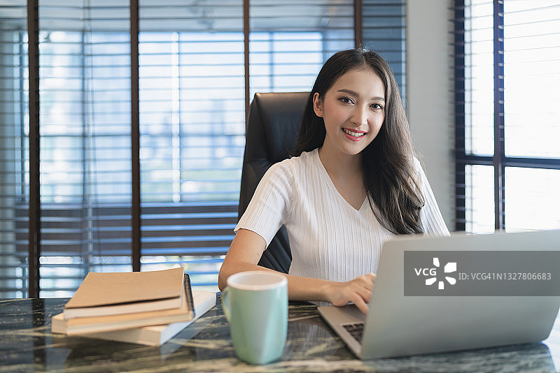 年轻亚裔女性在家进行视频会议，保持社交距离图片素材