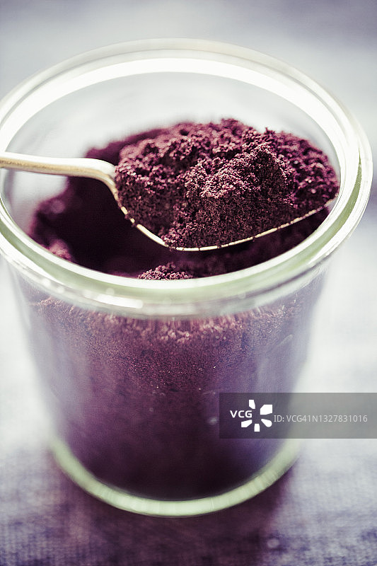 玻璃杯装阿萨伊粉和勺子图片素材