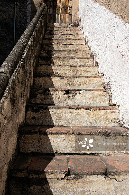 殖民建筑外墙上的旧灰泥、石头和赤陶瓦台阶图片素材