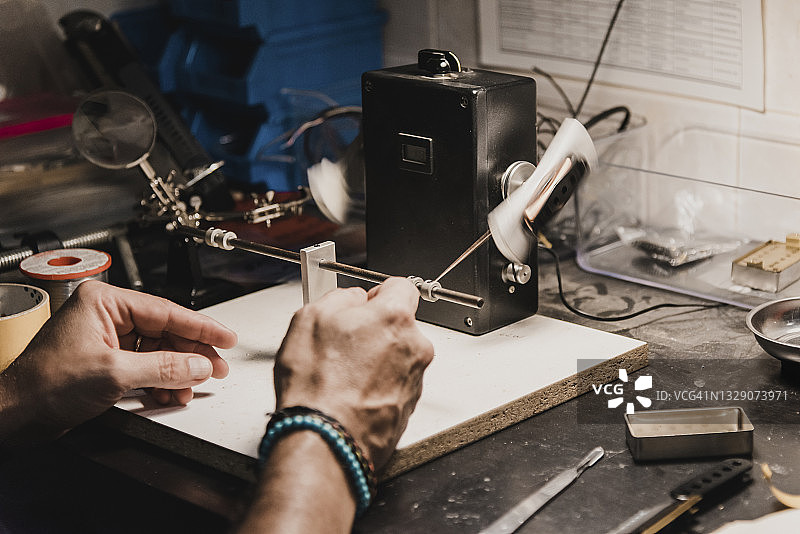 制琴师用绕线机缠绕吉他拾音器铜线图片素材