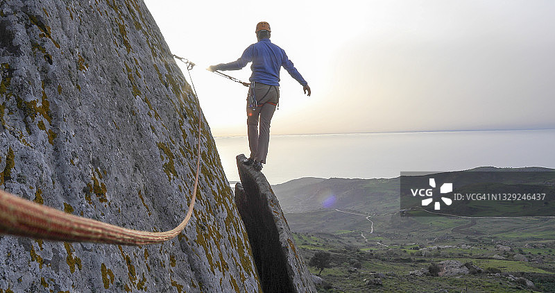 登山者在日出时攀登山脊图片素材
